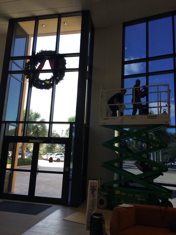Installers adhering window films at Gartner Inc. Fort Myers