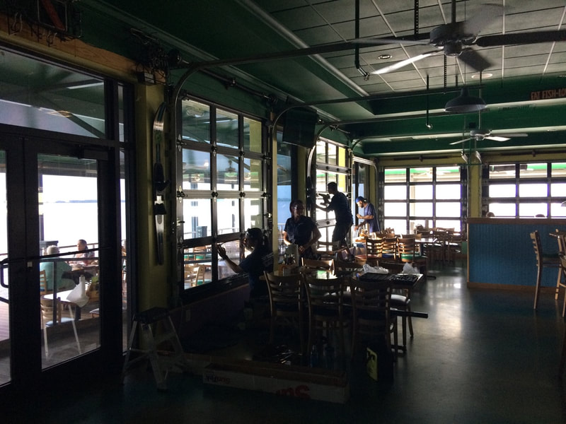 Beverly Hills Window Tinting installers working inside Pinchers Crab Shack. Fort Myers