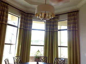 Custom curtains in dining room of home in Lely Resort on Trento Circle